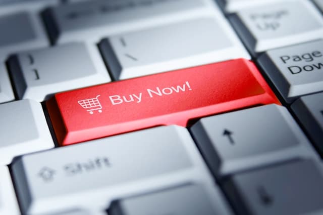 Red buy now button on a computer keyboar